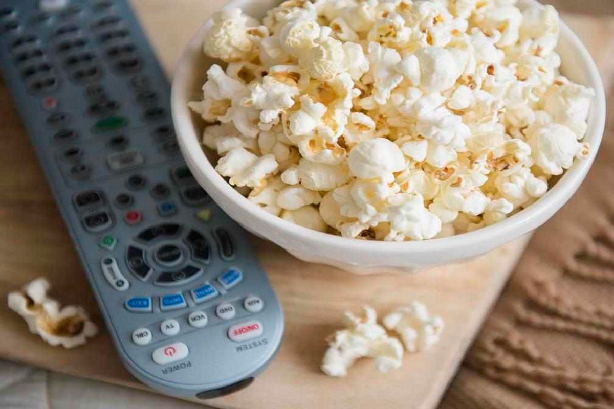 bowl of popcorn and tv remote