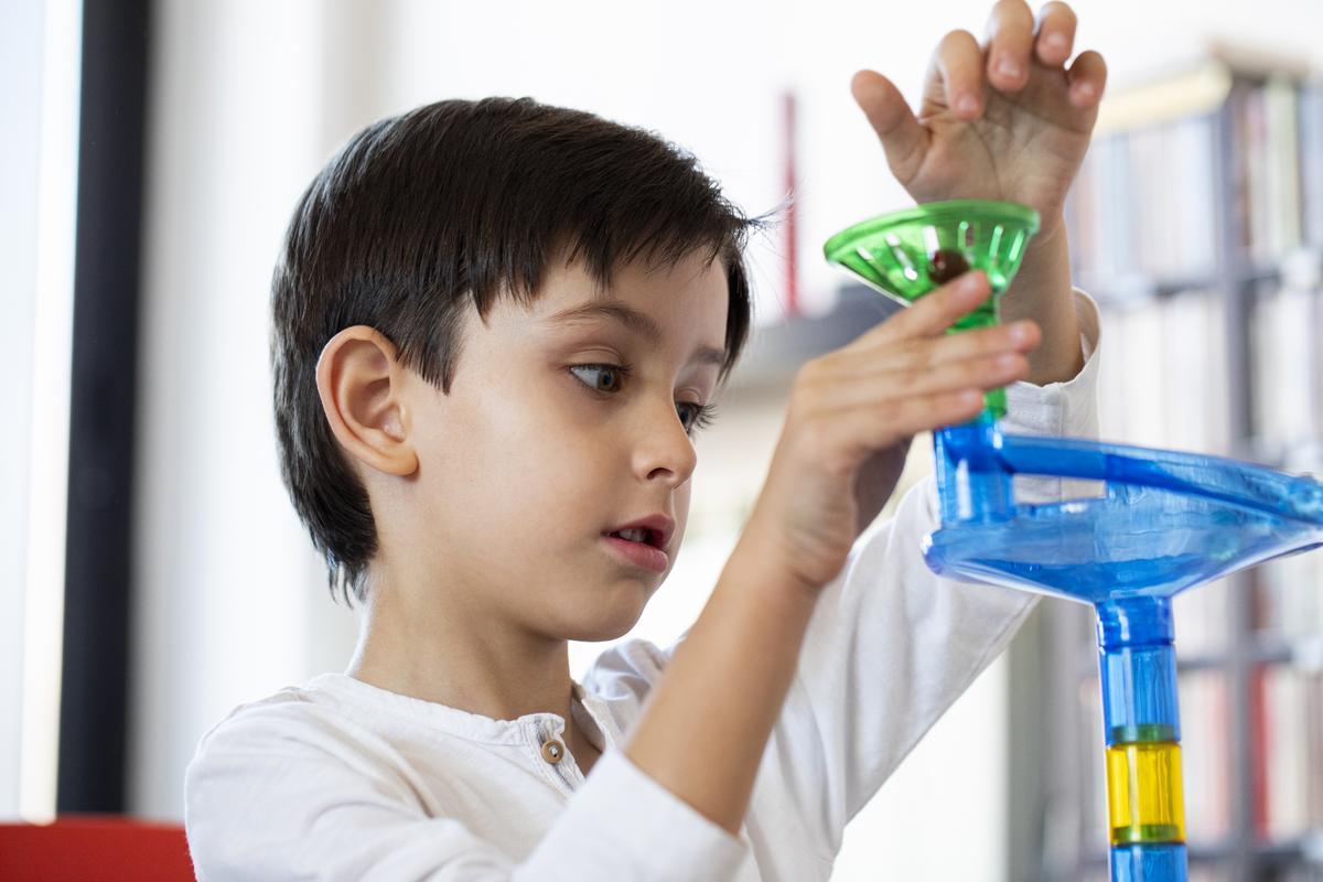 child playing with an science-related toy