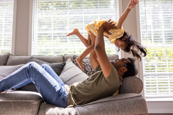 father holding child in the air