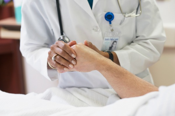 doctor holding patient's hand